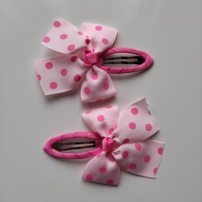 lot de 2 barrettes clic clac  noeuds gos grain rose à pois  B133