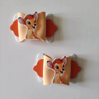 BAMB001 Lot de 2 barrettes crocodile noeuds orange et blanc   faon bambi